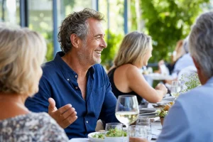 Confident man laughing with friends after same-day dental implants in Jerusalem